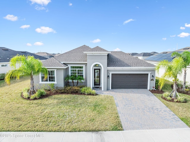 view of front facade featuring a front yard and a garage