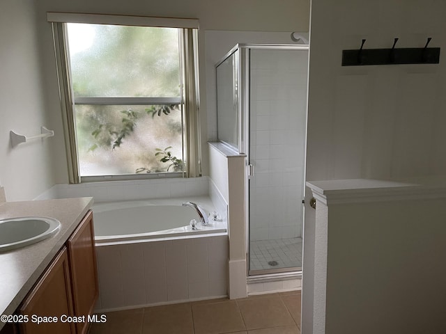 bathroom featuring separate shower and tub, tile patterned flooring, and vanity