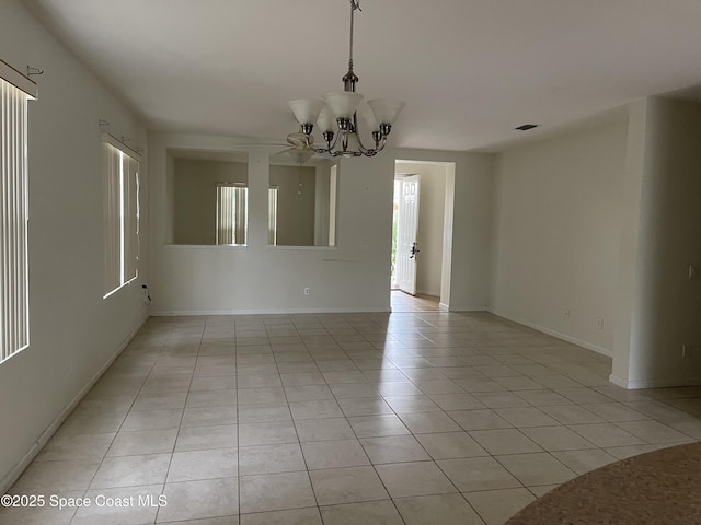 unfurnished room with light tile patterned floors and a notable chandelier