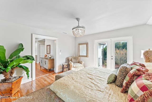 bedroom featuring light wood-type flooring, french doors, and access to outside