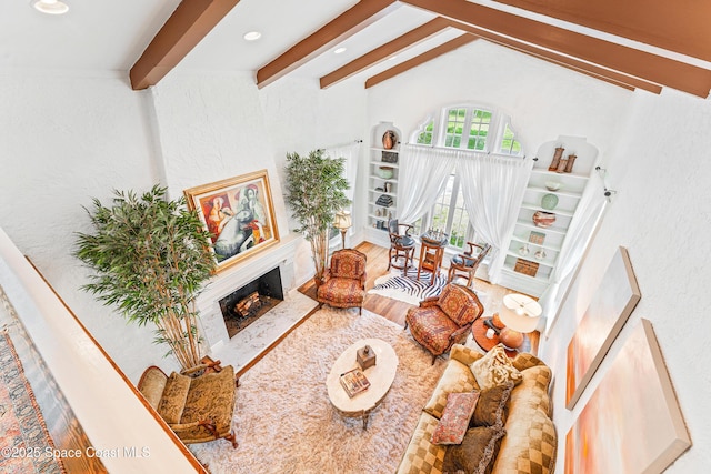 living room featuring wood-type flooring and vaulted ceiling with beams