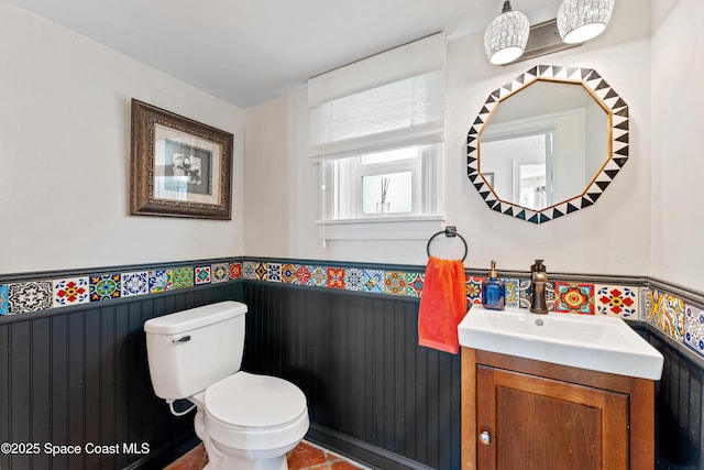 bathroom featuring toilet, vanity, and tile patterned flooring