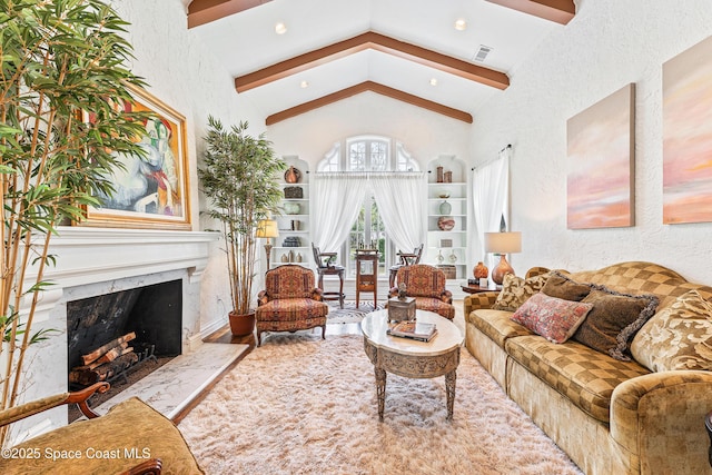 living room featuring vaulted ceiling with beams and a fireplace