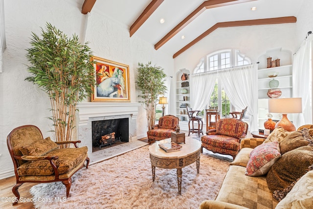 living room with high vaulted ceiling, a fireplace, wood-type flooring, and beamed ceiling