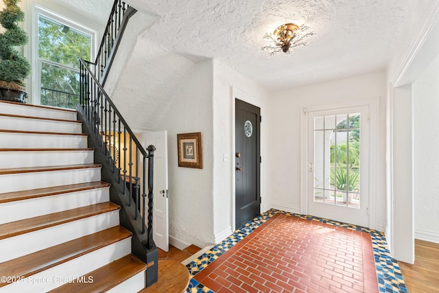 foyer with a healthy amount of sunlight and a textured ceiling