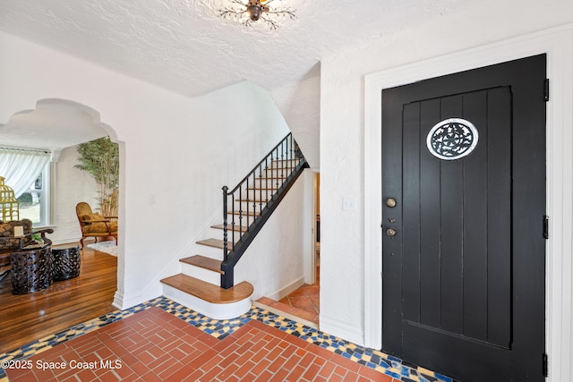 entryway featuring a textured ceiling