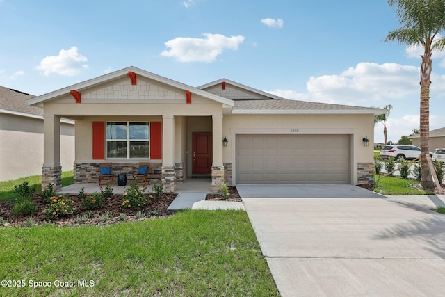 view of front of property with covered porch, a garage, and a front lawn