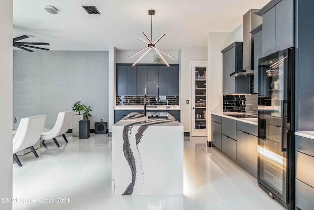 kitchen featuring pendant lighting, backsplash, sink, ceiling fan, and black electric cooktop