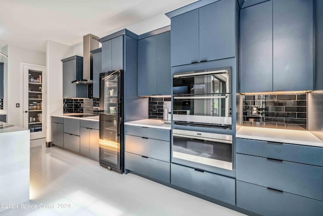 kitchen with decorative backsplash, double oven, and blue cabinetry