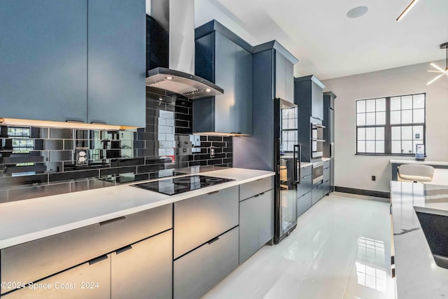 kitchen with backsplash, black electric cooktop, blue cabinetry, light tile patterned floors, and range hood