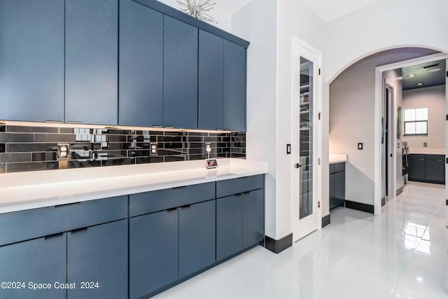 bathroom featuring vanity and tasteful backsplash