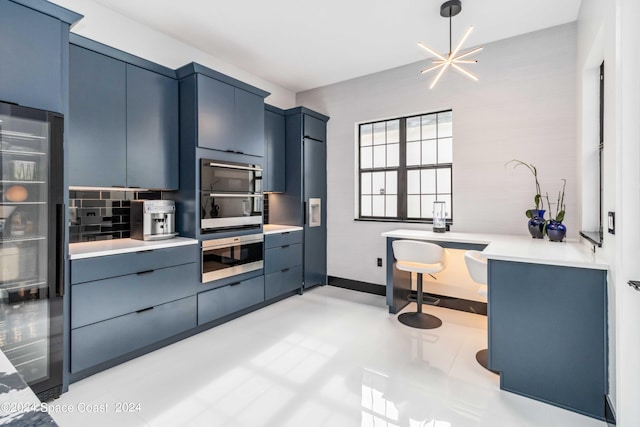 kitchen featuring an inviting chandelier, blue cabinetry, wine cooler, and tasteful backsplash