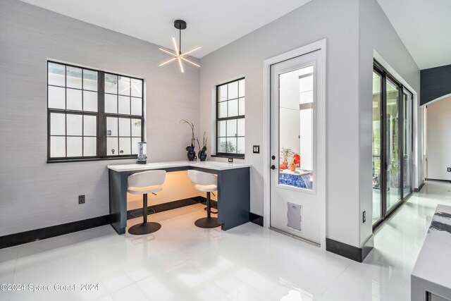 office area featuring light tile patterned flooring and a chandelier