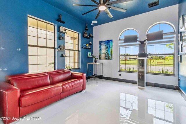 living room with tile patterned flooring, plenty of natural light, and ceiling fan