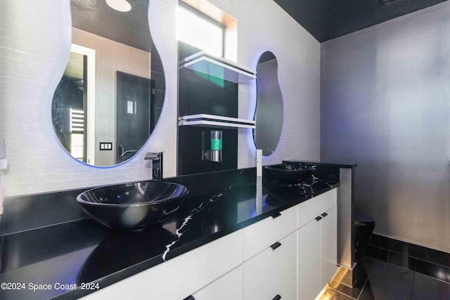 kitchen featuring white cabinets, backsplash, and sink