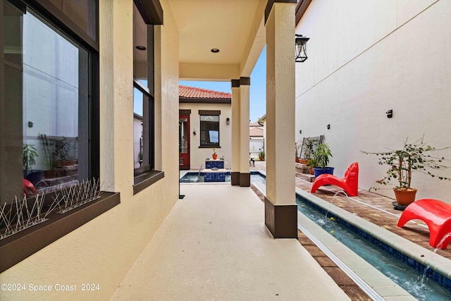 view of patio featuring pool water feature