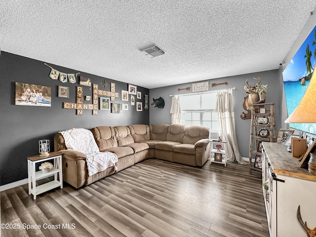 living room featuring a textured ceiling and dark hardwood / wood-style floors