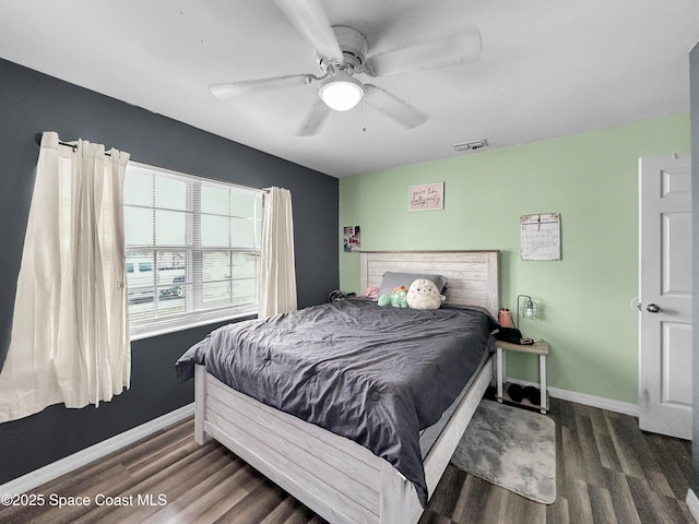 bedroom with ceiling fan and dark hardwood / wood-style floors