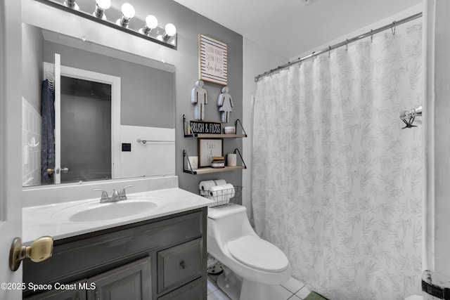 bathroom featuring tile patterned floors, toilet, and vanity