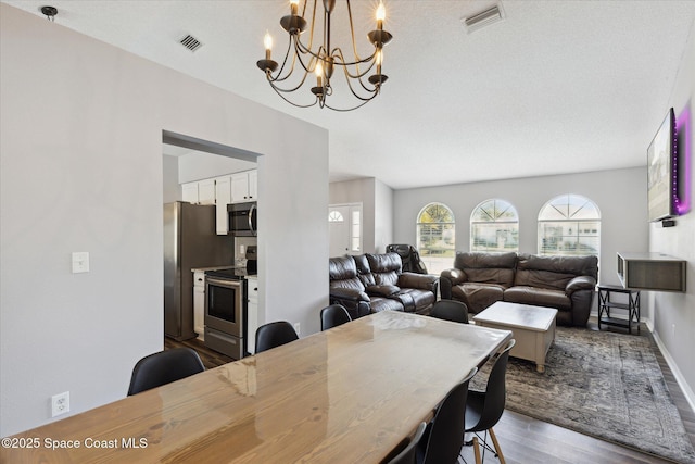 dining area featuring a chandelier and dark hardwood / wood-style flooring