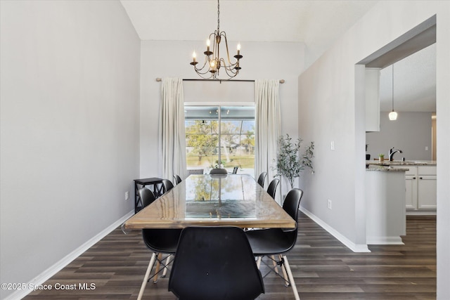 dining area featuring dark hardwood / wood-style floors, a chandelier, and sink