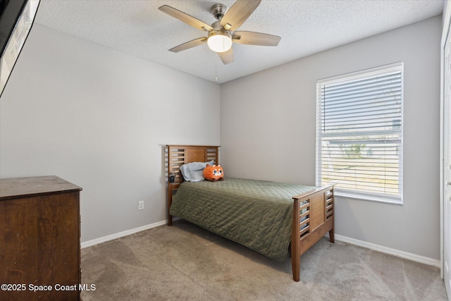 bedroom featuring ceiling fan, light carpet, and a textured ceiling