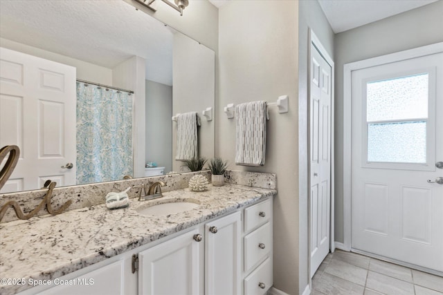 bathroom with tile patterned flooring, vanity, and toilet