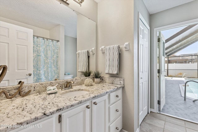 bathroom with tile patterned flooring, vanity, and toilet