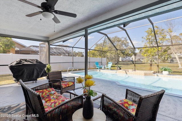 view of patio with a fenced in pool, ceiling fan, an outdoor hangout area, and glass enclosure