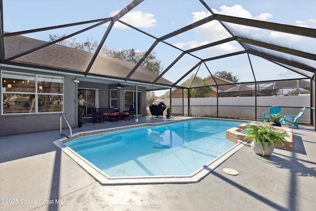 view of swimming pool featuring a lanai, a patio, and ceiling fan