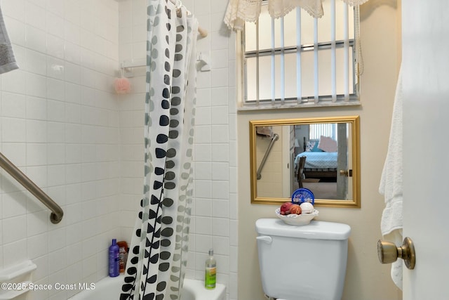 bathroom with toilet and shower / bath combo