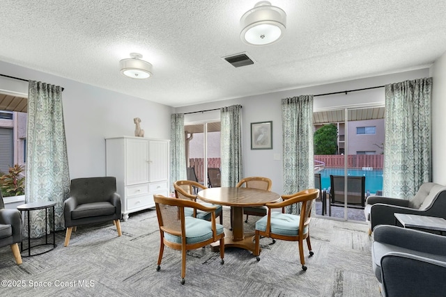 dining space featuring a textured ceiling