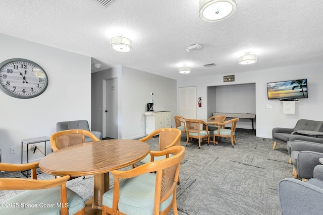 dining space featuring a textured ceiling