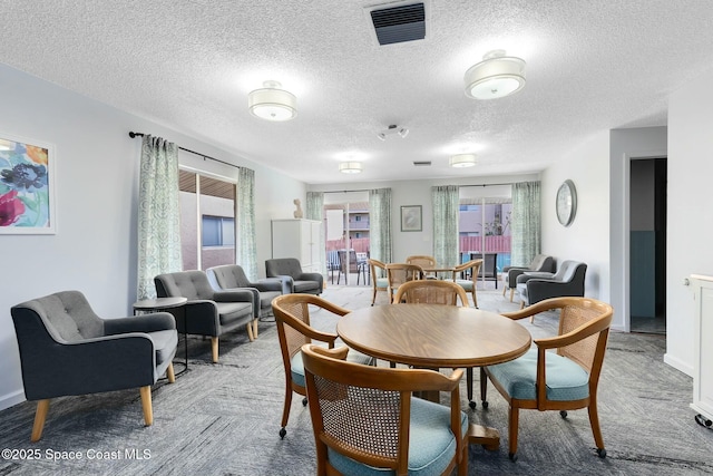 dining space with a textured ceiling