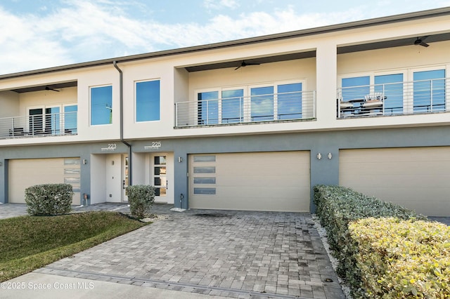 townhome / multi-family property featuring a garage and a balcony