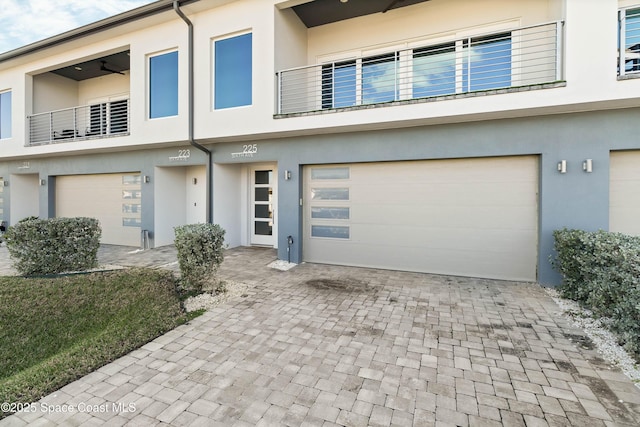 multi unit property with a balcony and a garage