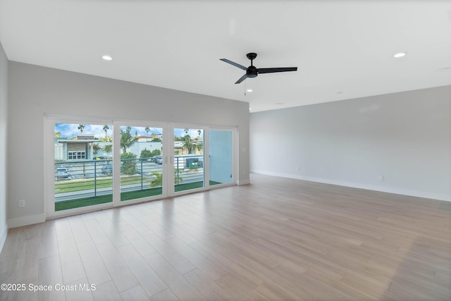 empty room featuring light wood-type flooring and ceiling fan