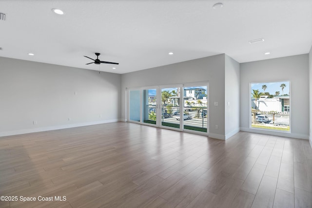 unfurnished room with ceiling fan and light hardwood / wood-style floors