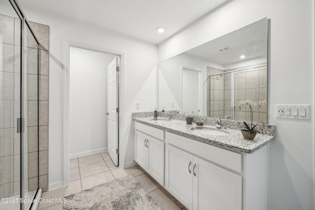 bathroom featuring vanity, tile patterned floors, and walk in shower