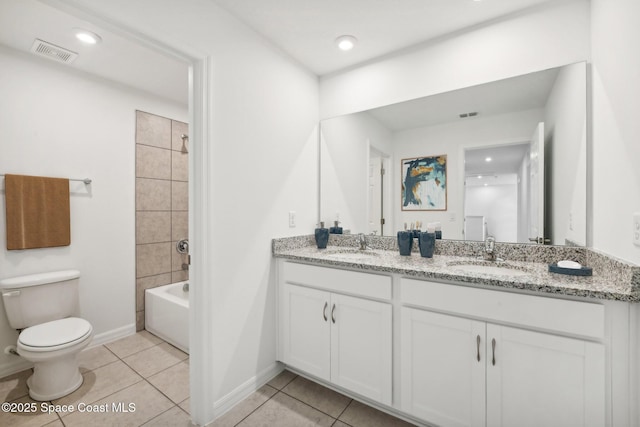 full bathroom with tile patterned floors, tiled shower / bath combo, toilet, and vanity