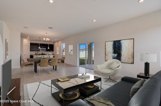 tiled living room with an inviting chandelier