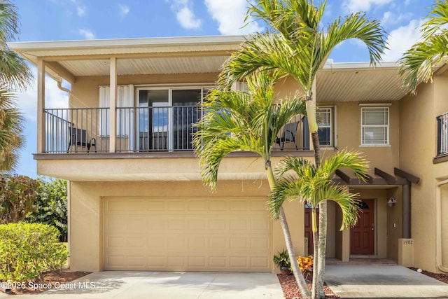 view of front of property with a balcony and a garage