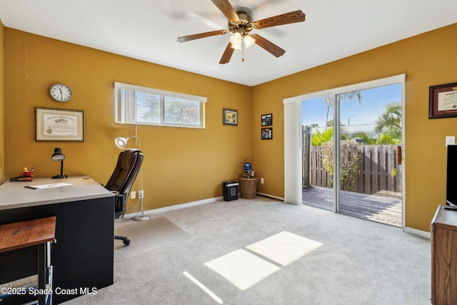 office area featuring light carpet and ceiling fan