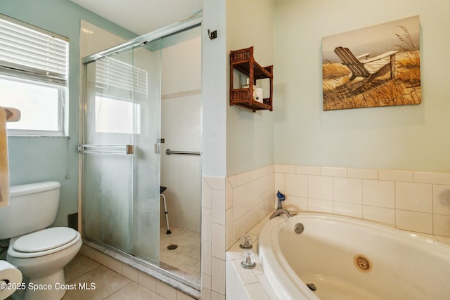 bathroom featuring toilet, tile patterned flooring, and separate shower and tub