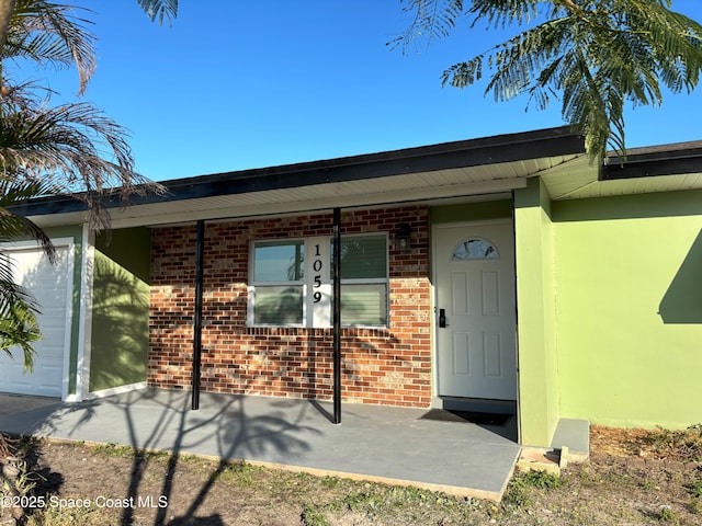 doorway to property with a patio area