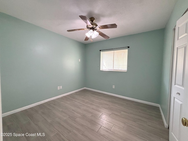 unfurnished bedroom with ceiling fan, a textured ceiling, and light wood-type flooring