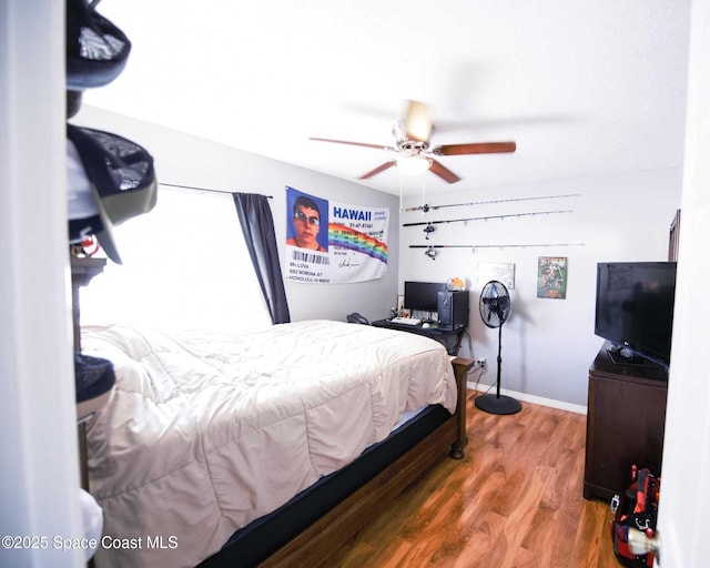 bedroom with ceiling fan and wood-type flooring