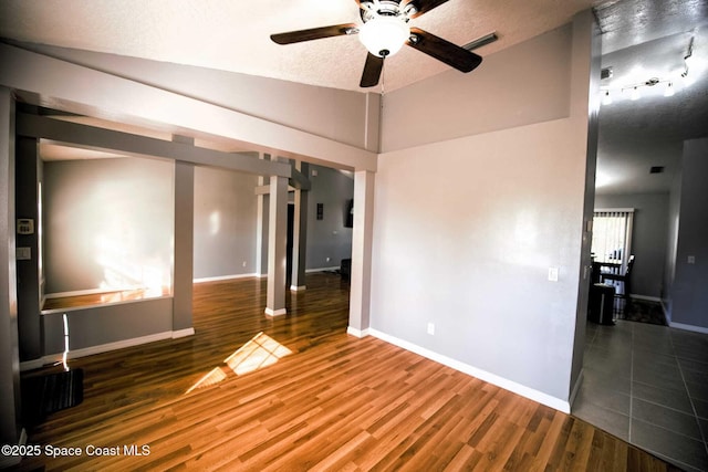 unfurnished room with lofted ceiling, ceiling fan, a textured ceiling, and hardwood / wood-style flooring