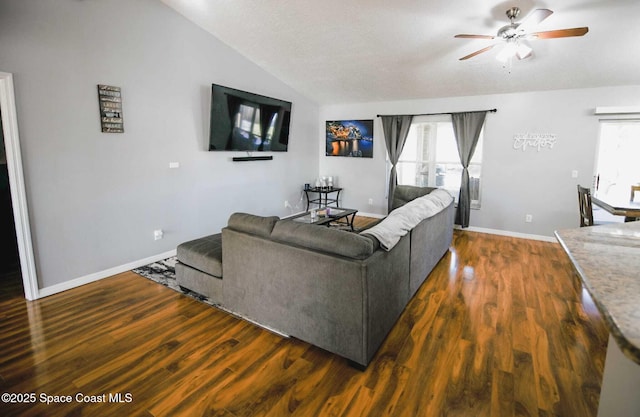 living room with ceiling fan, dark hardwood / wood-style flooring, and lofted ceiling