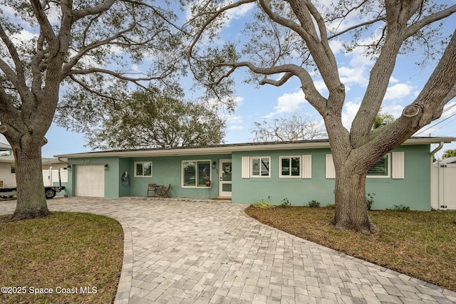 ranch-style home with a front lawn and a garage